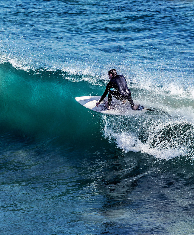 Surfer riding a Malibu wave