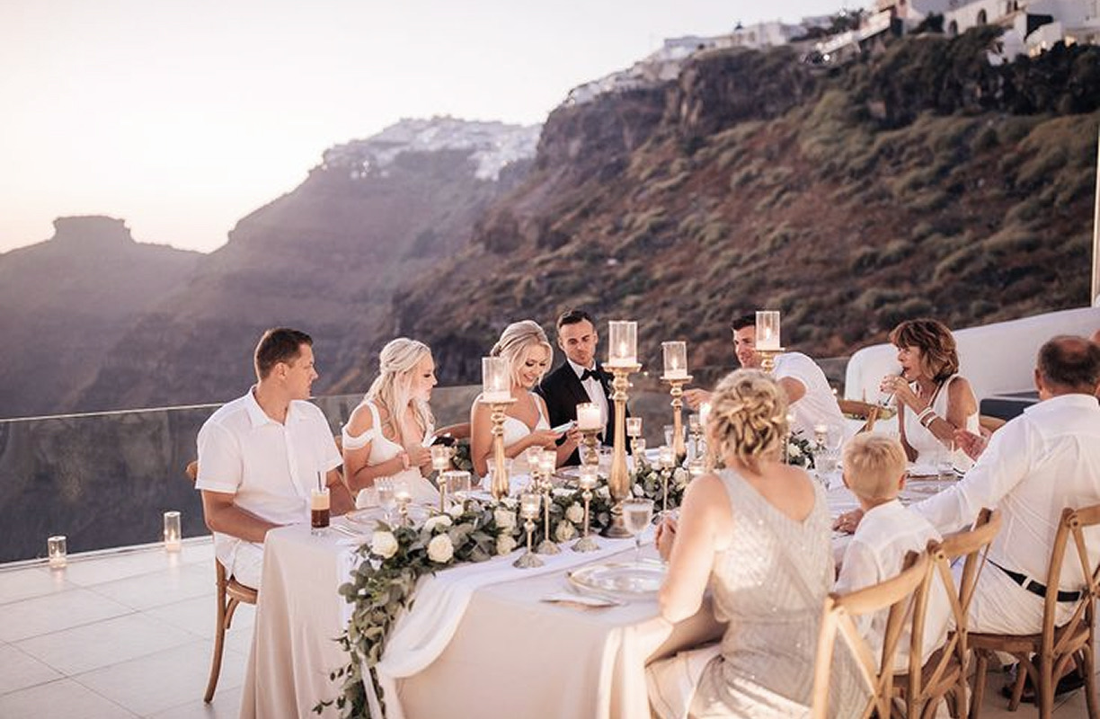Guests raising a toast at a round table at sunset