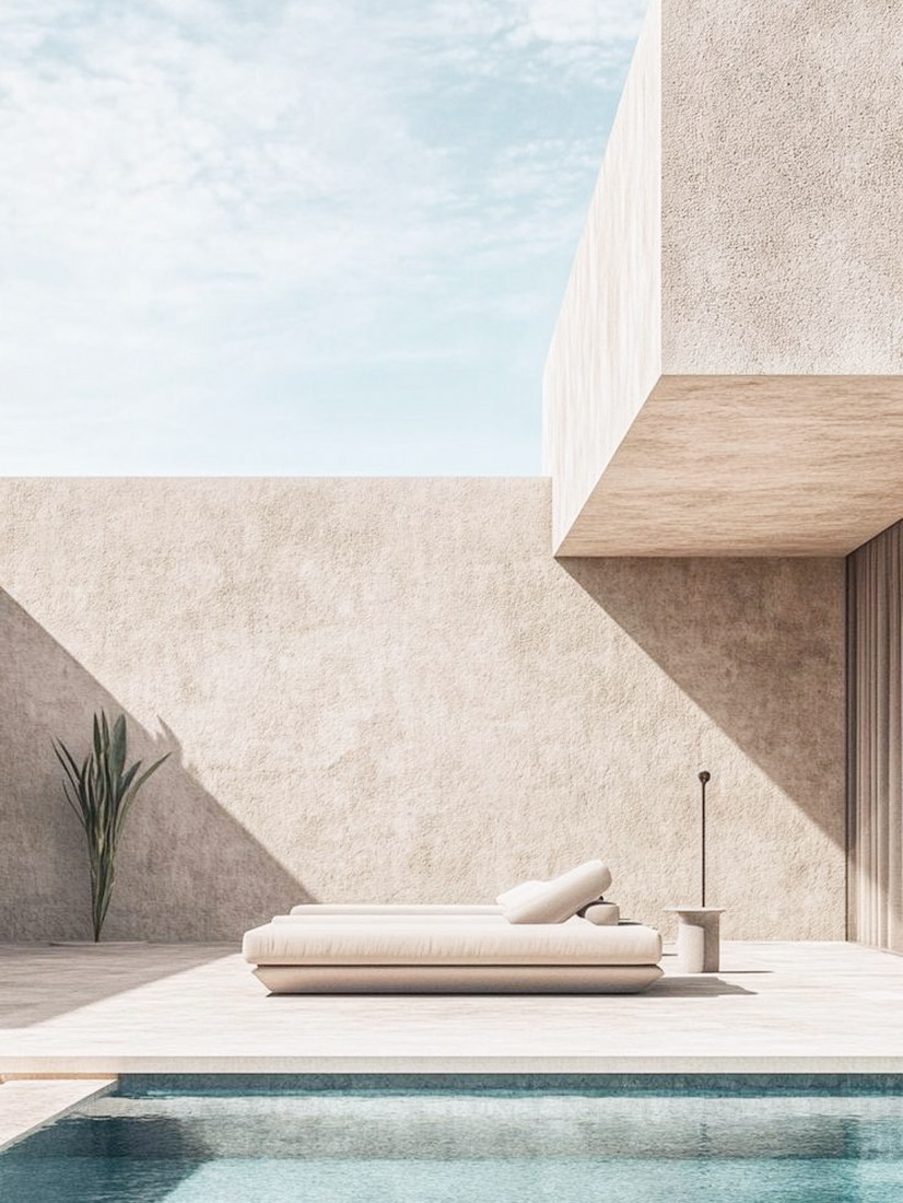 Daybed on the pool deck framed by rendered walls