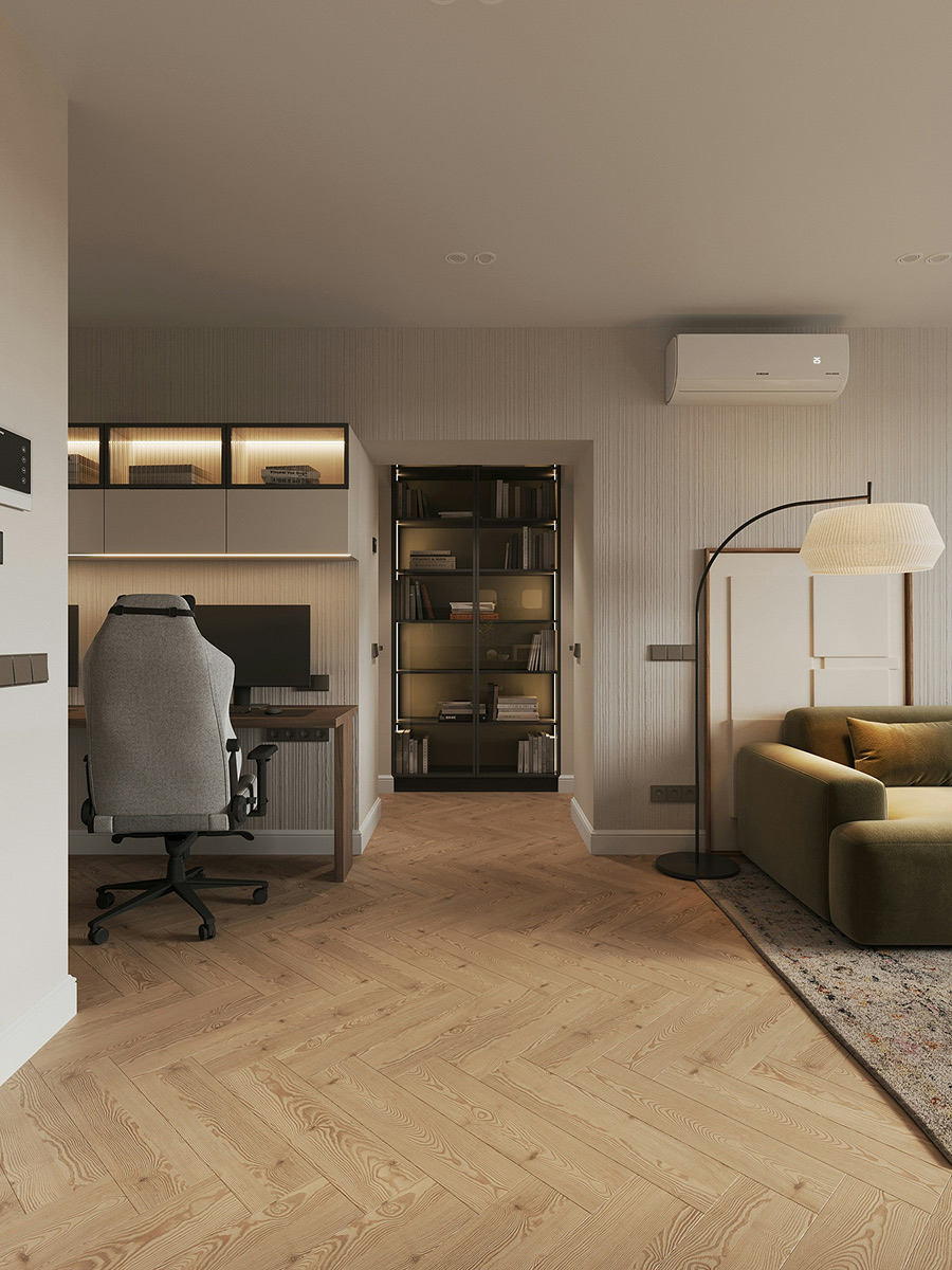 A home office with a desk, shelving and an olive sofa