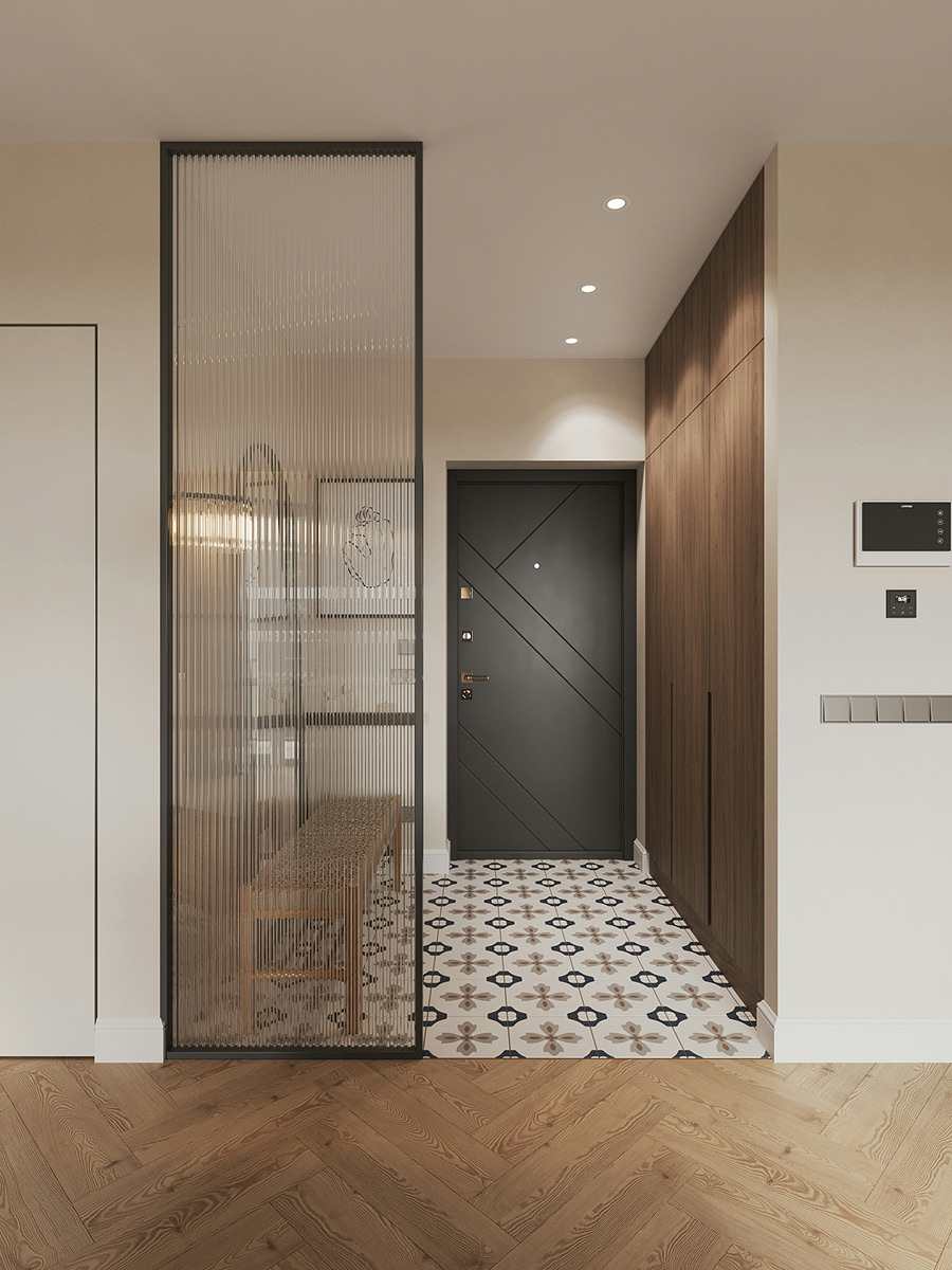 An entrance hall with a fluted glass screen and patterned tiles